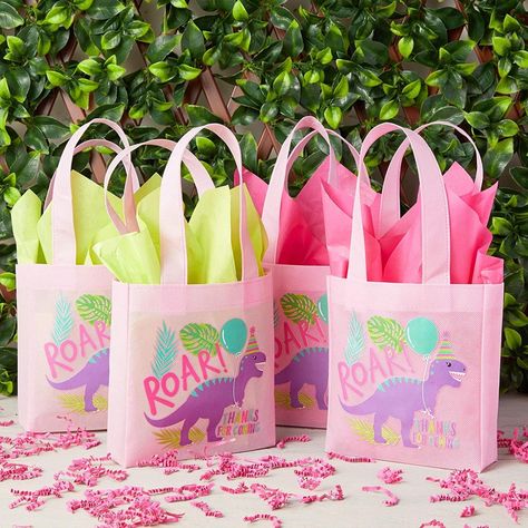 Party Favor Gift Bags: Our set of tote bags feature an adorable purple dinosaur wearing a birthday hat in the center of a light pink background; perfect for an upcoming dinosaur birthday party; ideal for storing candy, chocolate, and toys Dinosaur Party Decorations: Complete your dino party supplies with these pink favor bags; hand the treat-filled mini tote bags out to guests as they arrive, or place them on tables throughout the party venue Reliable Quality: The cute dinosaur birthday party fa Girl Dinosaur Party, Birthday Party Favor Bags, Toys Dinosaur, Dinosaur Birthday Theme, Purple Dinosaur, Dinosaur Party Decorations, Girl Dinosaur Birthday, Dinosaur Birthday Party Decorations, Dinosaur Party Favors