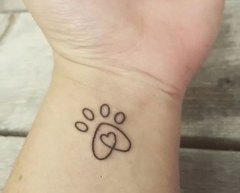 15 Simple Dog Tattoo Ideas: Embrace Your Canine Love Dog Memorial Tattoos Small Name, Wrist Paw Print Tattoo, Dog Mehendi Design, Dog Paw Tattoos For Women, Dog Paw Print Tattoo, Paw Print Tattoos, Ruby Tattoo, Tattoos On Wrist, Dog Tattoo Ideas