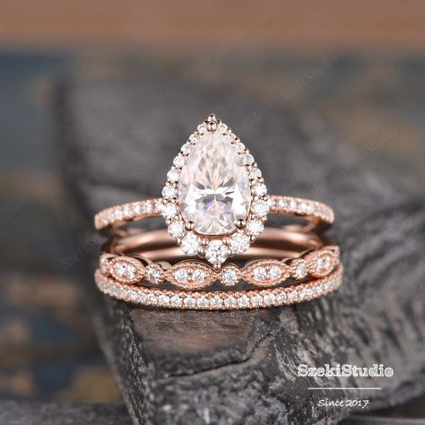 "3pcs Pear Cut Moissanite Engagement Ring Set Pear Shaped Wedding Ring Set Infinity Diamond Rose Gold Bridal Set Tear Drop Halo Ring Engagement ring: https://www.etsy.com/listing/1062234205 ITEM INFORMATION Metal Type - Solid 14k Rose Gold Band Width - (approx. 1.5mm) Center Stone: Moissanite, Pear Shaped * 6*9mm, about 1.6ct Color- D-E-F Clarity- VVS Side Stone - Natural Diamond or Colorless Moissanite Weight - 0.63ct Clarity -SI Color - H **Accent Stones: moissanite or diamonds can be selected. **Stone Replacement** Available with any other gemstones, please feel free to contact me for a quote. **Metal Type** Available in 14K or 18K yellow gold, white gold, and rose gold. Please select from the drop-down menu. **Production Time& Rush Order** Our standard production time is 3-4 weeks from Rose Gold Wedding Ring Sets Vintage, Teardrop Engagement Ring Rose Gold, Rose Gold Tear Drop Engagement Ring, Engagment Ring Sets, Wedding Bands For Pear Shaped Rings Halo, Rose Gold Engagement Ring Teardrop, Stacked Pear Engagement Ring, Rose Gold Pear Shaped Engagement Ring, Tear Drop Engagement Ring Set