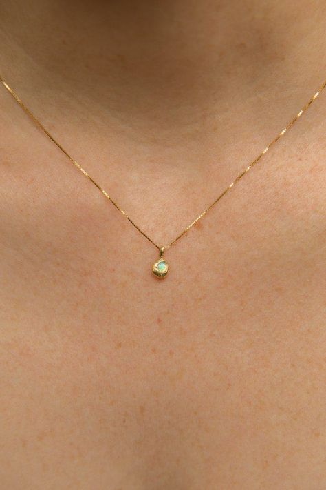 Solid 14k gold settings and dainty box chain. Ethically sourced, genuine 3mm Australian opal. Every stone is unique, varying in shades from blue green to pinky purple. Total width of pendant is approx. 6mm. Hand-formed and cast with recycled yellow gold, giving each one its own unique look and feel. This dainty design comes on a .5mm solid 14k gold box chain. Made ...#World #the #of #Elegance #Simplicity #and #Exploring #Beauty #Jewelry #Jewelry #Gemstone #Exploring #Minimalist #Embracing #of Simple Stone Jewelry, Dainty Gold Chain With Pendant, Fine Chain Necklace, Simplistic Gold Jewelry, Dainty Gold Pendant, Gold Simple Jewelry, Gold Fine Necklace, Simple Gold Necklace Designs, Gold Simple Necklace