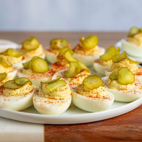 This dill pickle deviled eggs recipe is a delicious twist on a favorite holiday appetizer! Mix hard-cooked egg yolk with creamy mayonnaise, spicy brown mustard, pickle juice, and herbs for a flavorful deviled egg filling. Pickle Deviled Eggs Recipe, Dill Pickle Deviled Eggs, Pickle Deviled Eggs, Deviled Egg Filling, Pickled Deviled Eggs, Devil Eggs, Ready Set Eat, Best Deviled Eggs, Mustard Pickles