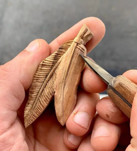 Patryk Roszak on Instagram: "Two feathers pendant, hand carved in plum wood 🪵 Work in progress!🪶🪶 - - - - - #wood #woodcarving #woodart #handmade #handmadewithlove #handmadejewelry #fineart #jewelryofinstagram #jewelrygram #jewelry #pendant #necklace #woodpendant #wooden #woodnecklace #woodjewelry #feather #giftideas #plumwood #feathers #handcarved #slowcraft #knifecarving #workinprogress #jewelryart #jewelryartist #nativeamerican #nativestyle #🪶" Wood Whittling Ideas, Whittling Pendants, Wood Carving Necklace, Wood Carved Pendants, Feather Wood Carving, Wood Carved Necklace, Carved Wooden Pendant, Ornamental Wood Carving, Nature-inspired Carved Pendant Jewelry