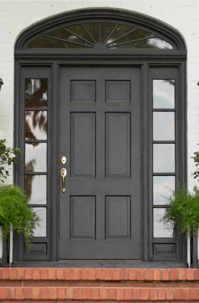 31 Houses With Black Front Entry Door Ideas | Sebring Design Build Black Front Door Entrance, Black Metal Entry Door, Black Exterior Doors Front Entry, Black Front Doors Exterior, Arched Front Door Entryway, Black Front Door Ideas, Entry Door Ideas, Black Entry Door, Rustic Front Door Decor