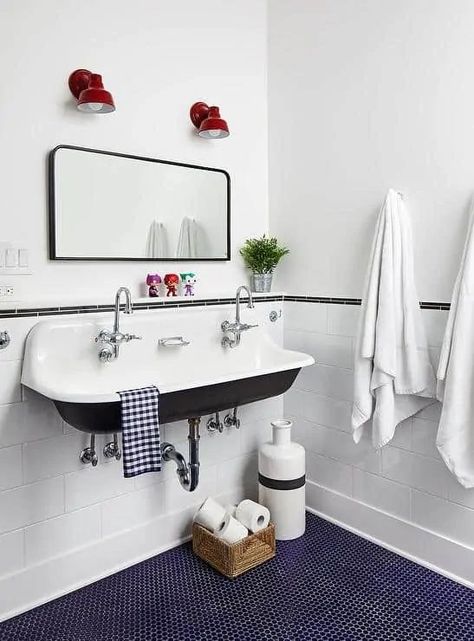 Picture of a vintage bathroom with white subway and navy penny tiles, a vintage sink, a mirror and red lamps plus textiles Kohler Brockway Sink, Blue Penny Tile, Penny Tiles Bathroom, Penny Tile Floors, Vintage Sink, Bright Bathroom, Trough Sink, Penny Tile, Cottage Bathroom