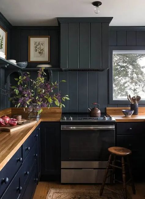 a black farmhouse kitchen done with beadboard, light colored wooden countertops and stools plus open shelving Navy Blue Beadboard, Black Beadboard Backsplash, Farmhouse Kitchen With Open Shelving, Kitchen With Beadboard, Dark Beadboard, Backsplash Beadboard, Black Beadboard, Black Farmhouse Kitchen, Blue Beadboard