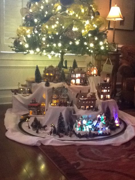 Christmas village under the tree Train And Village Under Christmas Tree, Christmas Train Under Tree, Under Tree Christmas Village, Christmas Village Display Under Tree, Christmas Tree With Village Underneath, Christmas Village Display Small Space, Christmas Village Under Tree Ideas, Christmas Tree Under Decor, Christmas Village Under The Tree