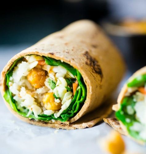 Packed with sweet and salty chickpeas, lots of herbs, cauliflower, spinach, and more, this wrap will satisfy pretty much any craving you might have. Get the recipe here. Per one serving: 360 calories, 19 grams protein Garlic Chickpeas, Vegan Honey, Wraps Recipes Healthy, Roasted Chickpea, Pastas Recipes, Lunch Wraps, Healthy Wraps, Veggie Wraps, Healthy Recipe Videos