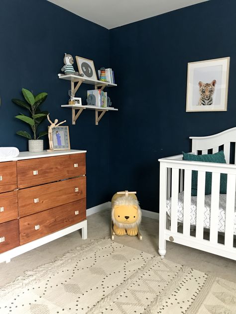 Dark wall nursery, moody nursery, navy blue nursery, boy nursery, safari nursery, tribal nursery, dark blue nursery, neutral nursery, wood tones nursery, tarva dresser hack Navy Wall Nursery, Navy Blue Nursery Gender Neutral, Dark Blue Baby Room, Dark Wall Nursery, Dark Blue Nursery Boy, Navy Safari Nursery, Navy Walls Nursery, Dark Blue Nursery Ideas, Dark Blue Kids Room