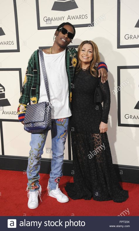 Google  A$AP Rocky did it again.  He wore this outfit to the 2016 Grammy's.  This messenger bag from Goyard had everyone talking.  His Gucci, and Goyard collaboration was a success.  What rapper can pull off a messenger bag at the Grammys?  A$SAP Rocky of course.  What's even cooler is that he paid tribute to his rapper friend A$AP Yams who had passed, bringing his mother as his date. Gucci Messenger Bag Outfit, Goyard Bag Outfit, Goyard Messenger Bag, Messenger Bag Outfit, Gucci Messenger Bags, The Grammys, Bag Outfit, Goyard Bag, Cool Outfits For Men