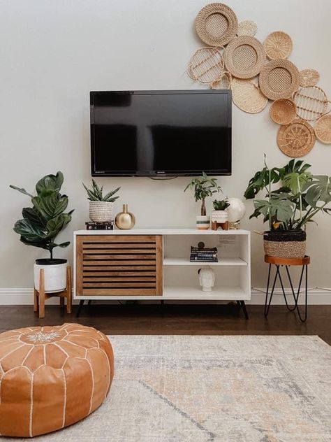 Tv Stand Boho Living Room, Basket Walls Boho Living Room Tv, Boho Bedroom Tv Stand, Boho Living Room Entertainment Center, Western Boho Tv Stand Decor, Modern Boho Living Room With Tv, Bohemian Living Room Tv Stand, Entertainment Center Decor Boho, Plants Next To Tv Stand