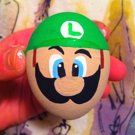 Luigi painted egg for my man on easter. It's his fav :) Easter Egg Characters, Dinosaur Egg Rock Painting, Dragon Egg Rock Painting, Easter Egg Painting Characters, Easter Egg Competition Ideas, Minion Easter Eggs, Cool Easter Eggs, Egg Rock, Egg Tree