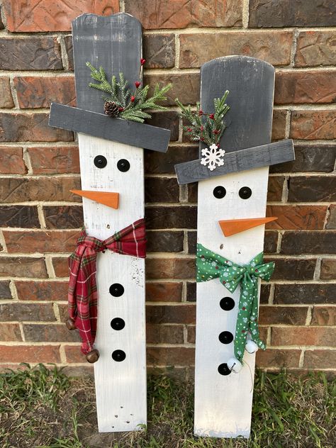 "These wooden snowmen yard or porch decorations are made using reclaimed wood and painted white with white wash effect. These are sold separately but can be purchased as a set. The snowman has a red checkered scarf and the snow woman has a green scarf. These can be propped up or can be purchased with hardware. That would include the metal brackets as well as the metal post.  Measurements: 34.5\"x5\" 34\"x5.5\" These are individuals and can be placed close to each other or apart. Due to the nature of using reclaimed wood, we can not guarantee each snowman will look the same as the picture. We will do our best to ensure that they match.  More in our shop: Decorative tray: https://www.etsy.com/listing/1522192427/14-custom-decorative-tray-gift-for-her Decorative Christmas books: https://little Reclaimed Wood Christmas Decor, Christmas Signs Wood Front Porches, Snowmen Decor, Front Porch Decorations, Outdoor Snowman, Christmas Diy Wood, Wood Yard Art, Wooden Snowmen, Christmas Snowmen