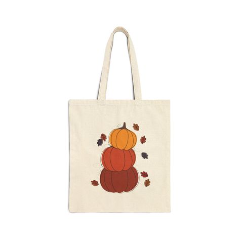 Three Cute Stacked Pumpkins with Fall Leaves | Cotton Canvas Tote Bag | Shoulder Bag | Gift Bag | Trick or Treat Bag  - 100% Cotton canvas for durability  - Flat corners for a sleek look  - Bag size is 15" x 16"  - 20" handles  - Heavy fabric (12 oz/yd² (406.9 g/m  - Perfect for everyday wear Care instructions: - Do not iron directly over the printed area - print may stick to the iron. - Spot clean - Do not bleach - Line dry Fall Tote Bag Painting Ideas, Fall Tote Bag, Fall Tote, Stacked Pumpkins, Halloween Tote, Trick Or Treat Bags, Reusable Bags, Fall Leaves, Treat Bags