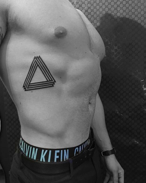 Black, triple Penrose triangle tattoo on the right rib Impossible Triangle Tattoo, Penrose Triangle Tattoo, Rib Cage Tattoo, Girl Rib Tattoos, Cage Tattoo, Rib Tattoos For Guys, Impossible Triangle, Penrose Triangle, Moth Tattoo Design