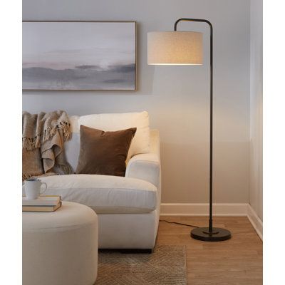 Slender and streamlined, this floor lamp brings a touch of contemporary style as it illuminates any space in your home. Founded atop a round base, this metal fixture features an arched body that props up a single light, while a hardback drum shade up above completes the understated design and diffuses its brightness. Some assembly is required, and this luminary does not include a compatible 100W incandescent bulb. Langley Street® Shade Color: Natural Linen, Finish: Oil Rubbed Bronze | Langley St Sunroom Lighting, Dining Room Floor Lamp, Standing Lamp Living Room, Tall Floor Lamps, Pole Lamps, Stylish Floor Lamp, Corner Lamp, Industrial Floor Lamps, Tall Lamps