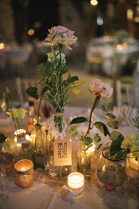 Bottles Jars Flowers Tea Lights Bottles Stylish Pastel Rustic Barn Wedding http://helenrussellphotography.co.uk/ Gin Bottle Flowers Wedding, Mason Jar Tea Lights Wedding, Mason Jar Fairy Light Wedding Centerpieces, Wedding Table Flowers Rustic Mason Jars, Jam Jar Wedding Centre Pieces, Wedding Bottles, Wedding Reception Flowers, Rustic Centerpieces, Whimsical Wonderland Weddings