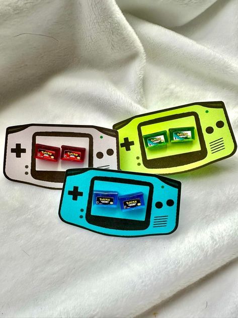 Nintendo Switch Pokemon Earrings inspired by the Pokemon video games. Cute video game earrings perfect for a any gamer gift. Pokemon Sapphire, Pokemon Ruby and Pokemon Emerald pictured as Pokemon Earrings. Gamer earrings Video Game Earrings Gamer Gifts Nintendo Switch Video game jewelry Game jewelry Nintendo jewelry Nintendo earrings Pokemon earrings Pokemon Jewelry Pokemon emerald Pokemon Ruby Pokemon Sapphire Stud earrings Cartridge Earrings, Nintendo Earrings, Gamer Earrings, Nintendo Switch Pokemon, Nintendo Jewelry, Game Earrings, Pokemon Earrings, Video Game Jewelry, Gamer Style