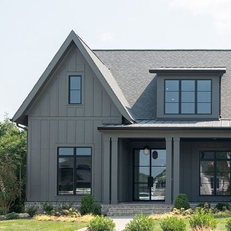 Legend Homes LLC on Instagram: "Dark exteriors are in right now, but is this a trend you would get behind? It’s a total win in our book. Comment and let us know your thoughts!" Grey Board And Batten Exterior Black Windows, Dark Gray House With Wood Accents, Vertical Board And Batten Siding, Dark Grey House Black Windows, Dark Gray House Black Trim, Midnight Shadow Lp Siding, Dark Gray Siding, Vertical Siding Exterior Color Schemes, Grey Board And Batten Exterior