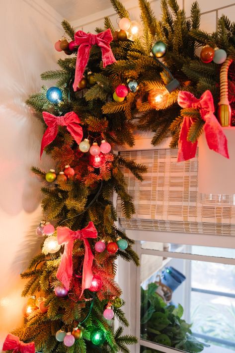 Kitchen Christmas Garland with Ribbon - Blushing Bungalow | So Cute You'll Blush ☺️ Colored Lights On Christmas Tree, Christmas Decor Bright Colors, Retro Christmas Garland, Pink Retro Christmas Aesthetic, Over The Top Christmas Tree, Christmas Tinsel Garland Ideas, Christmas 90s Aesthetic, Tinsel Garland Ideas, Christmas Garland With Ribbon