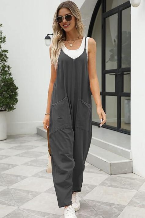 Step out in style with this effortless summer outfit Featuring a trendy grey jumpsuit paired with a white top, this look is perfect for casual outings or a day of shopping. Accessorized with stylish sunglasses and a chic handbag, this ensemble is both comfortable and fashionable. Embrace laid-back summer vibes without compromising on style! . SummerStyle #OutfitInspiration #CasualChic #JumpsuitFashion #TrendyLooks Tampa Florida Outfits, Jumpsuit Summer Outfit, Summer Jumpsuit Outfit, Chic Bodycon Dress, Summer Onesies, Baggy Overalls, Jumpsuits Casual, Florida Outfits, Womens Jumpsuits Casual