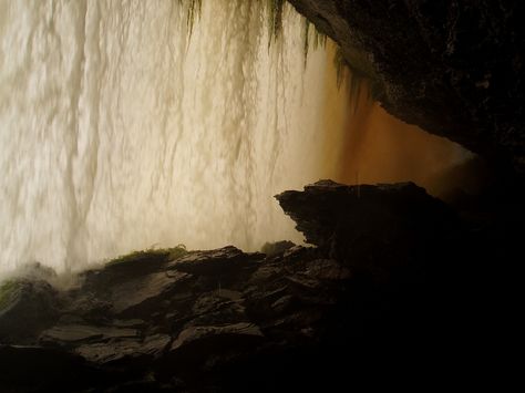 go behind a waterfall Behind Waterfall Caves, Hidden Cave Behind Waterfall, Cave Behind Waterfall, Behind Waterfall, Premonition Series, Behind A Waterfall, Aesthetic Scenery, Cliff Face, Background Reference