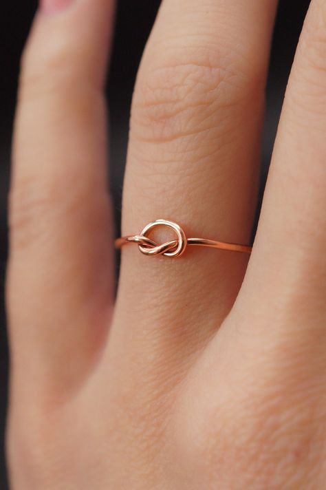 This stacking Knot ring is really cute and easy to wear! The open wire knot adds a bit of extra detail to this otherwise simple hammered stacking ring. This is one single length of metal that is knotted into a secure, open knot and soldered around the back. This ring is a great alternative to a stacking ring! This listing is for ONE SINGLE RING. Each ring is made from 14K ROSE GOLD. Choose from THIN (.7mm) or THICK (1mm) metal. NOTE: Due to the delicate nature of our Thin rings we recommend remo 14k Rose Gold Filled Ring, Rose Gold Infinity Ring, Friendship Anniversary, Gold Infinity Ring, Promise Band, Gold Stacking Rings, Single Ring, Stacking Ring Set, Infinity Ring