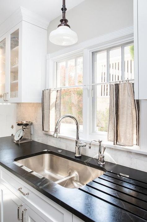 More innovative and functional, a built in dish drainer is designed in this kitchen countertop for functionality and ease. Transitional Farmhouse Kitchen, Coastal Transitional Decor, Green Soapstone, Schoolhouse Light, Living Room Paint Color Ideas, Living Room Paint Color, Leather Couches, Transitional Farmhouse, Kitchen Sinks Farmhouse