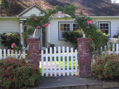 I like the family name sign hanging from the arbor. Maybe do this instead and get a new mailbox with our address on that. Or put a little placard on one of the brick pillars with our address Brick Pillars, Home Fencing, Green Fence, Natural Fence, Brick Fence, Concrete Fence, Lattice Fence, Front Yard Fence, Farm Fence