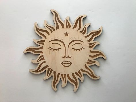 This unique home decor piece is made of wood and features a laser-cut sun face. It is perfect for adding a touch of warmth and sunshine to any.#laserdecor #cuttingedge #homedecor #lasercutart #decorinspo Lcd Units, Window Seat Design, Laser Cut Decor, Wooden Sun, Sun Wall Art, Wood Items, Laser Engraved Ideas, Sun Face, Stylish Wall Art