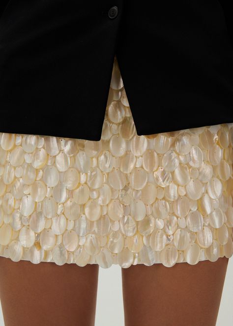 A super short mini skirt fully embellished with genuine mother of pearl for a one of a kind piece. Mini Skirt Sequin, Statement Mini Skirt, Styling Sequin Skirt, Mood Board Wedding Inspiration, Sequin Mini Skirt Outfit, Pearl Embellished Dress, Mini Shorts Outfit, Sequin Shorts Outfit, Shell Embellishment