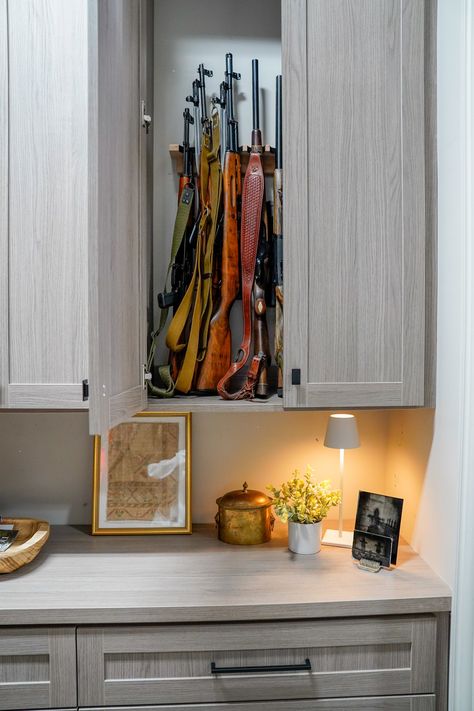 Concealed behind a cabinet door, the gun storage in this hunting room offers secure and discreet protection for firearms, ensuring the safety and peace-of-mind for the homeowner. Hunting Gear Closet, Home Armory, Hunting Closet, Hunting Gear Storage, Armory Room, Hunting Storage, Tuscaloosa Alabama, Utility Closet, Country Squire