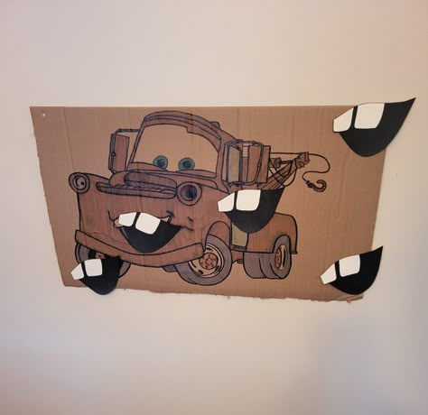 I printed an image on Mater on multiple pages to achieve my desired size;  traced it on to a piece of cardboard and colored it in. Using my orignal print, I traced his mouth onto card stock paper and simply used a black sharpie to color in the darkness of his mouth. Pixar Cars Birthday Party Activities, Cars Birthday Party Games Activities, Mater Party Ideas, Cars Birthday Games, Mater Themed Birthday, Cars Birthday Activities, Pixar Cars Birthday Party Decorations, Cars Pixar Birthday Party Ideas, Tow Mater Birthday Party