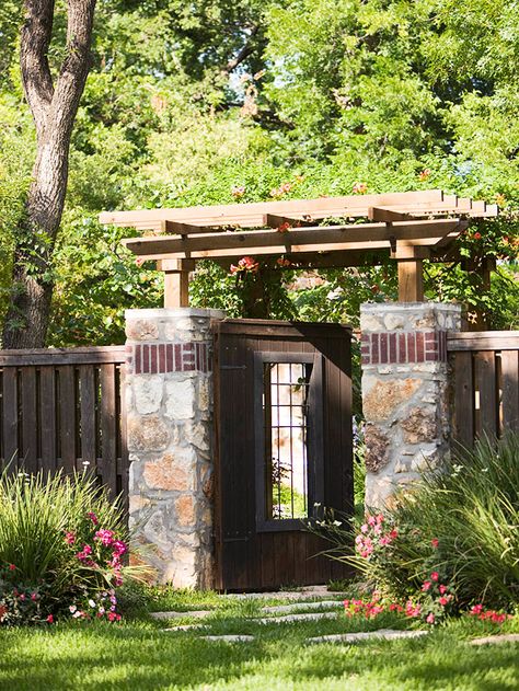 Geometry and material choices are key to enhancing the traditional style of the overhead section.  Wood and stone are the two primary materials in this arbor and fence, but a slight flair in the construction of the fence creates visual variety.  Randomly spaced pavers direct visitors under the structure. Tor Design, Garden Arch Trellis, Garden Fence Ideas, Types Of Bricks, Wooden Gate, Arch Trellis, Wooden Pergola, Front Gates, Wooden Gates