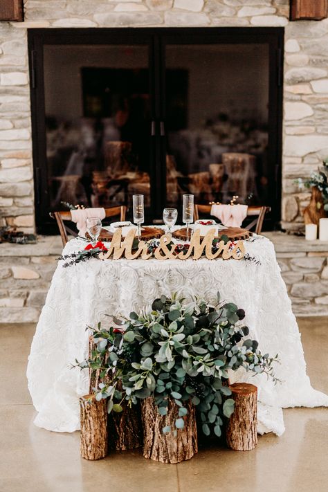 Wood stump arrangement with greenery in front of head table, gold Mr. and Mrs. signs, ivory rosette tablecloth, fireplace head table  Venue: The Sycamore Winery Photography: Kayla Lynn Creative Floral: Cowan & Cook Food: Edibles Catering Rustic Bride And Groom Table Ideas, Inside Wedding Arch, Front Of Head Table Decor, Wedding Party Head Table Decor, Mr And Mrs Table Decoration, Me And Mrs Table, Western Sweetheart Table, Wedding Signing Table Ideas, Mr And Mrs Table Wedding