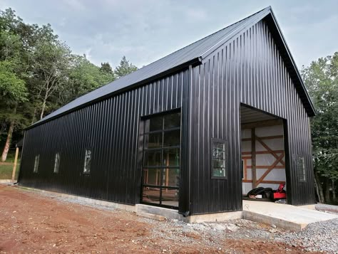 @blackbarnsocialclub’s Instagram post: “Y'all, I can't even emote enough. This #blackbarn has been in my mind for over a decade. To see it slowly coming to life is beyond…” Black Metal Shop, Black Metal Barn, Black Pole Barns, Barn Garage Ideas, Pole Building Garage, Steel Garage Buildings, Barn Style Garage, Metal Garage Buildings, Pole Barn Garage