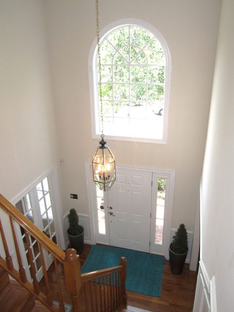 Foyer With High Ceiling Entrance, 90s Entryway Makeover, Staircase At Front Door Entryway, Double Foyer Entryway, Tall Entry Way Ideas, Colonial Entryway Foyers, High Ceiling Entryway Ideas, Chandelier Foyer Entryway High Ceiling, High Ceiling Foyer Ideas Entryway