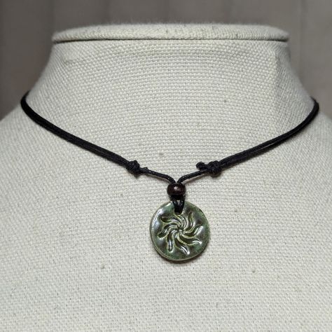 Earth Toned Green Ceramic Pendant Handmade Spiral Swirl Sun Burst Charm Boho Gothic Whimsigoth Hippie Adjustable Black Rope Cord Choker Stacking Necklace Comes On An Adjustable Waxed Black Cord Necklace. Necklace Is Adjustable From Approximately 13" To 22". To Wear Your Necklace Pull The Two Knots Away From The Pendant To Adjust To A Larger Size, Leave About An Inch Of Space Between The Two Knots To Prevent It From Getting Stuck. Put Cord Around Your Neck And Pull The Two Knots In The Opposite Direction To Adjust To A Smaller Size. Handmade Enamel Jewelry, Handmade Earthy Adjustable Necklace, Adjustable Earthy Pendant Necklaces, Earthy Handmade Necklace With Waxed Cord, Handmade Earthy Pendant Jewelry, Earthy Gifts, Ceramics Pendant, Black Handmade Hippie Necklace, Whimsigoth Clothes