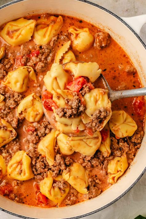 A tasty, creamy Beef Tortellini Soup recipe that the whole family will love. Made with ground beef, diced tomatoes, onions, beef broth, cream, and tortellini. This flavorful soup is the perfect for chilly days or when you're craving something comforting and hearty. Slow cooker option included. Creamy Beef Tortellini, Beef Tortellini Soup, Beef Broth Soup Recipes, Ground Beef Diced Tomatoes, Tortellini Soup Crockpot, Beef Tortellini, Quick Soup Recipes, Recipes Using Ground Beef, Tomato Tortellini Soup