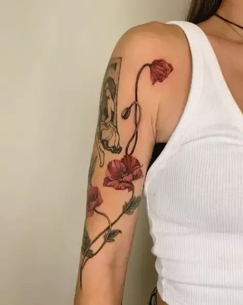 Captivating poppy flower tattoos that hold deep symbolism. Find inspiration for your next ink with these stunning designs. #tattooideas #poppytattoo #symbolism Painted Flower Tattoo, Amarilis Flower Tattoo, Poppy Tattoo Ideas, Burgundy Tattoo, Poppies Flower Tattoo, Poppy Flower Vine Tattoo, Pink Poppy Tattoo, Red Poppies Tattoo, Poppy Leg Tattoo