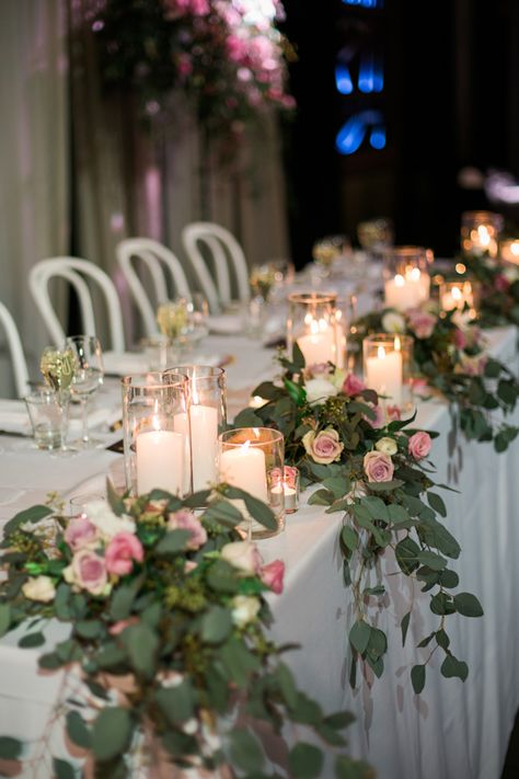 Whimsical bridal table bouquets of native gums and soft pink and mauve flowers combined with glass candle holders Bridal Table Flowers Arrangements, Bridal Table Flowers, Table Greenery, Top Table Flowers, Brides Table, Wedding Top Table, Bride Groom Table, Mauve Flowers, Bridal Party Tables