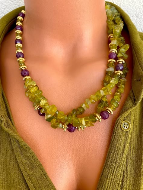 Ruby and Raw Peridot Asymmetrical Necklace This unique necklace is a great gift for yourself and your loved ones. Made from genuine Raw Peridot (Chrysolite) and Ruby beads. All metal ornaments are gold plated and won't get darker in time!  FREE SHIPPING ✈️✈️ - All orders get shipped within 1-2 business days. - 5-10 days of delivery time Returns are allowed 14 days after the delivery, however, the cost of delivery lies on the buyer. For more bracelets and necklaces!: https://finecrystalsdesign.et Collar Verde, Women Christmas Gifts, Raw Peridot, Asymmetrical Necklace, Peridot Jewelry, Ruby Beads, Women Christmas, Unique Jewelry Designs, Design Jewelry