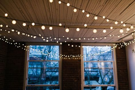 11 Scandinavian Lighting Tricks to Fill Your Home With Hygge | Use string lights to create a festive atmosphere Living Room String Lights, String Lights Living Room, Room String Lights, String Lights In The Bedroom, Hanging String Lights, Scandinavian Lighting, String Ball Lights, Indoor String Lights, Romantic Lighting