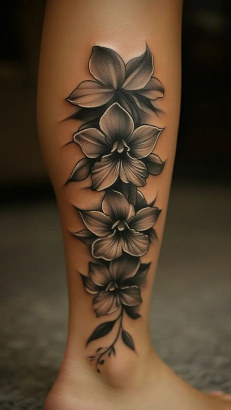 Discover the beauty of flower ankle tattoos for women! Looking for some elegant inspiration? Check out these delicate and charming flower ankle tattoos. Whether you prefer large or small designs, there's something for everyone to love. These floral ankle tattoos are perfect for adding a touch of femininity and grace to your look. Embrace the exquisite details and intricate patterns that make flower ankle tattoos a popular choice among women worldwide. Bottom Feet Tattoos For Women, Butterfly Flower Ankle Tattoo, Down The Leg Tattoos Women, Dafodill Flowers Tattoo Design, Above The Ankle Tattoo, Black And White Flowers Tattoo, Calf Cover Up Tattoos For Women, Leilani Flower Tattoo, Foot Tattoos For Women Black Woman