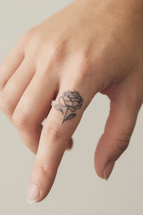 Tiny peony on finger tattoo Peony Minimalist Tattoo, Tiny Peony Tattoo, Simple Peony Tattoo, Small Peony Tattoo, On Finger Tattoo, Tattoo On Finger, Tiny Wrist Tattoos, Peony Tattoo, Peonies Tattoo