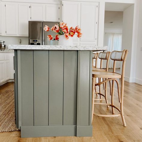 One of my favorite parts of our house is the green shiplap on our island. We had the cabinets painted white, but chose the color Eclipse from sherwinwilliams for the island. It is a soothing shade and really helps to ground the space! Swipe through to see our kitchen’s transformation! Wood Feature Kitchen Island, Green Shiplap Island Kitchen, Painting Peninsula Different Color, Center Island Color Ideas, Beige Cabinets Green Island, White Kitchen Cabinets With Color Island, Kitchens With Contrasting Islands, Painted Shiplap Island Kitchen, Kitchen Island Vertical Shiplap