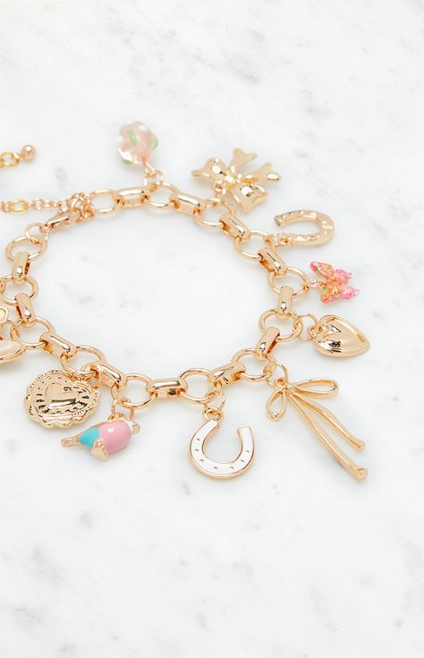 Add a touch of personality to your look with the Pink Charm Bracelet from LA Hearts. Featuring a chunky chain adorned with various charms, including dainty bows and butterflies, this bracelet is perfect for adding a playful elegance to any outfit.   	Lobster clasp closure 	Chunky chain 	Various charms Friendship Bracelets Charms, Gold Bracelet With Charms, Christmas Wishlist Ideas Aesthetic, Charm Bracelet Ideas, Cute Charm Bracelets, Charm Bracelet Aesthetic, Bracelet Charms Gold, Pink Charm Bracelet, Disney Charm Bracelet