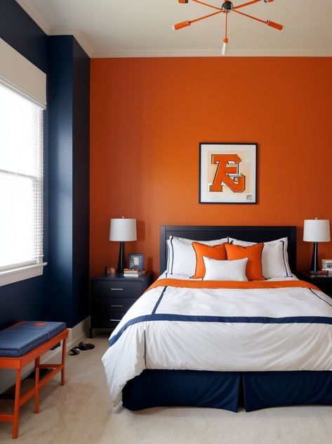 Create a vibrant and energetic boys bedroom by adding an orange accent wall, complemented with a cool sports-themed wallpaper. Complete the look with sleek black furniture and pops of blue for a modern and stylish space. Bedroom Orange Accents, Boys Bedroom Orange, Orange Accent Wall, Orange Bedroom Ideas, Orange Accent Walls, Sports Themed Bedroom, Blue Boys Bedroom, Orange Bedroom, Bedroom Orange