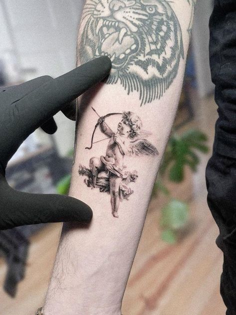 Microrealistic cupid tattoo #microrealismtattoo #smalltattooideas Tattoos On People, Daniel Tattoo, Cupid Tattoo, Live In Europe, Armor Tattoo, The Celts, Single Needle Tattoo, Flip Book Animation, Nordic Vikings