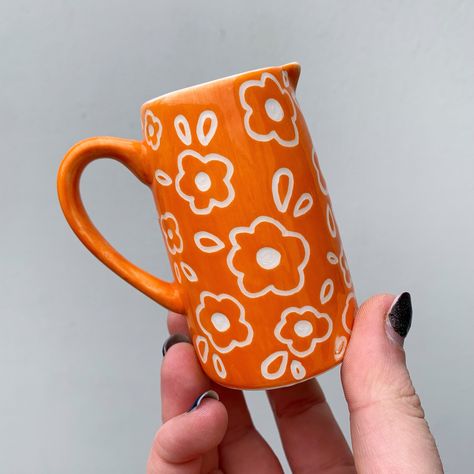 Totally forgot to post this little orange jug that sold a while back, such a pretty colour! ✨🧡🍊 Lots of other ceramics are available on my website now, link in bio 🥰✨ #art #artist #ceramics #pottery #painting #illustrator #ceramicstudio #potterytiktok #potterypainting #painter #potteryart #ceramicpainter #floral #bisqueware #glaze #glazedip #creative #smallbusiness #smallbusinessowner #smallartist #floral #plate #potterylove #decor #botanical #botanicalart #potteryprocess #potteryfeature #p... Funky Pottery Painting, Pottery Painting Jug, Vase Pottery Painting Ideas, Pottery Vase Painting Ideas, Underglaze Painting On Pottery, Painted Pot Ideas, Simple Pottery Painting, Paint Pottery, Diy Pottery Painting