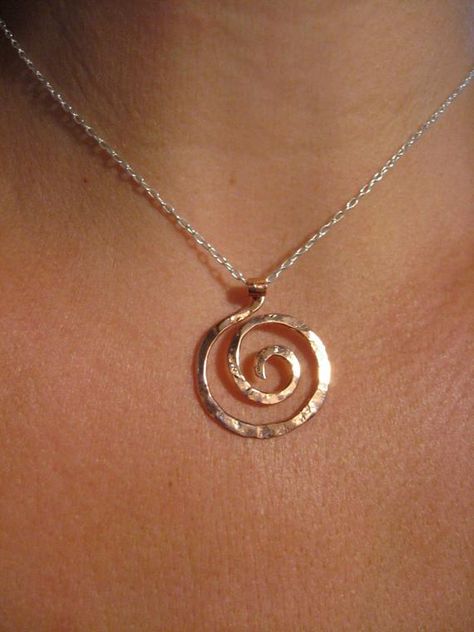 SIZE: Medium Pendant 1 1/4" x 1"  (16" or 18") will come in 16" unless specifiedThis small spiral pendant is inspired by the graceful spirals of the nautilus. Each spiral is hand shaped, hammered with my signature textured from my antique anvil. The texture comes from years of history, transferring every nick, dent and cranny which is transferred to the metal with every hammer strokeGreat for every day, this small spiral pendant hangs from a delicate sterling chain with spring clasp and daisy lo Copper Pendant Necklace, Gaia Statue, Temple Jewelery, Sacred Spiral, Spiral Goddess, Spiral Tattoos, Spiral Jewelry, Ring Holder Necklace, The Nautilus